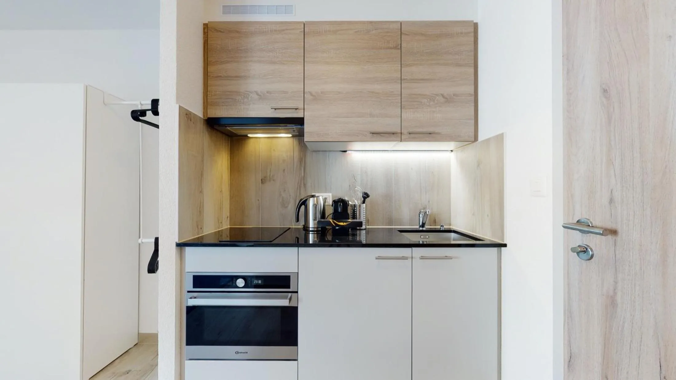 Kitchen or kitchenette in Nonanteneuf appart hōtel Aigle - contactless check-in