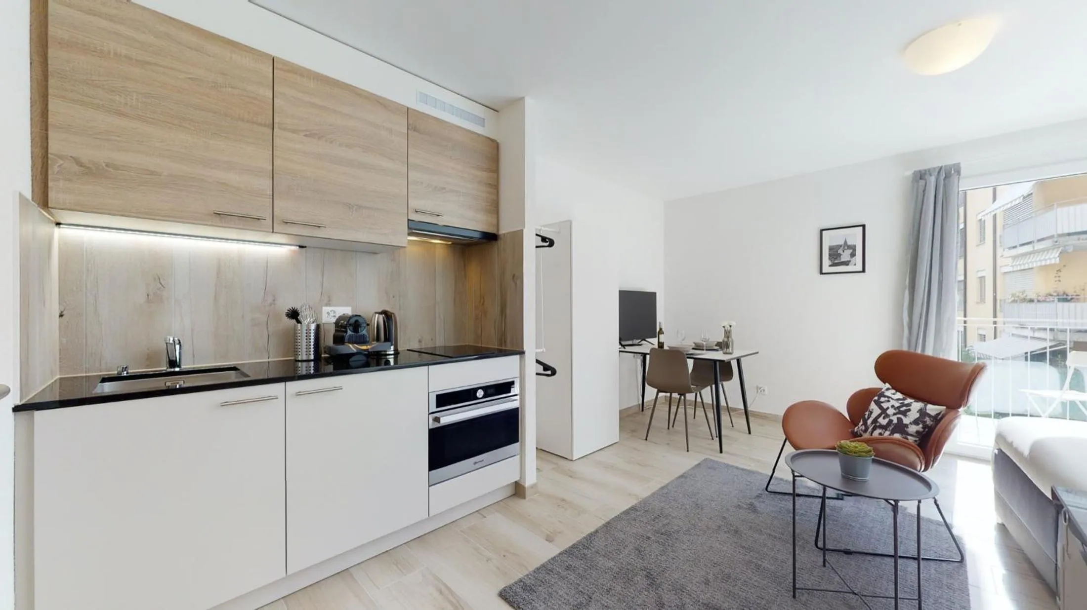 Kitchen or kitchenette in Nonanteneuf appart hōtel Aigle - contactless check-in