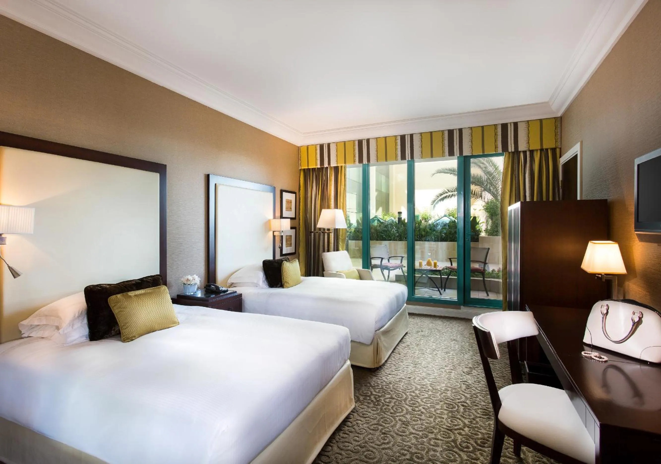 Bed in Mövenpick Grand Al Bustan