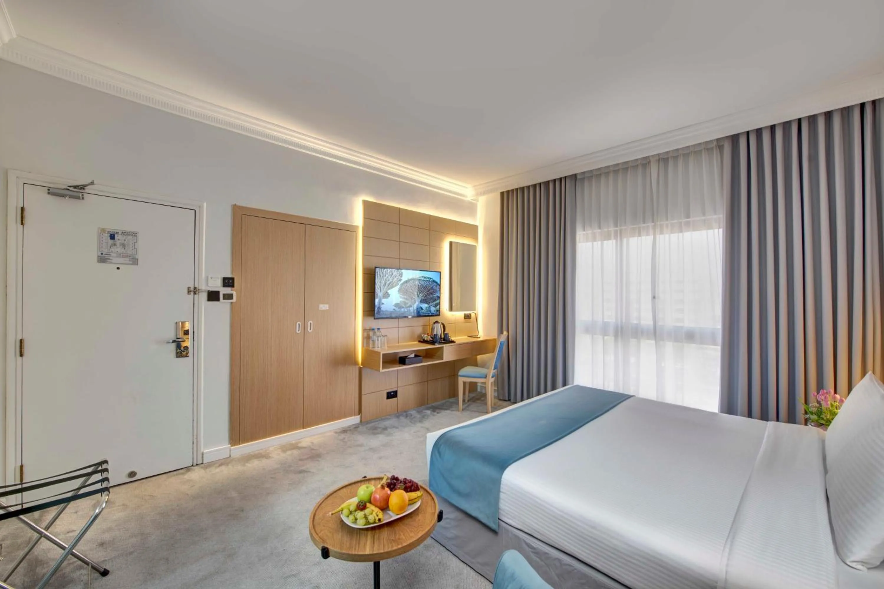 Communal lounge/ TV room, Bed in Lotus Grand Hotel