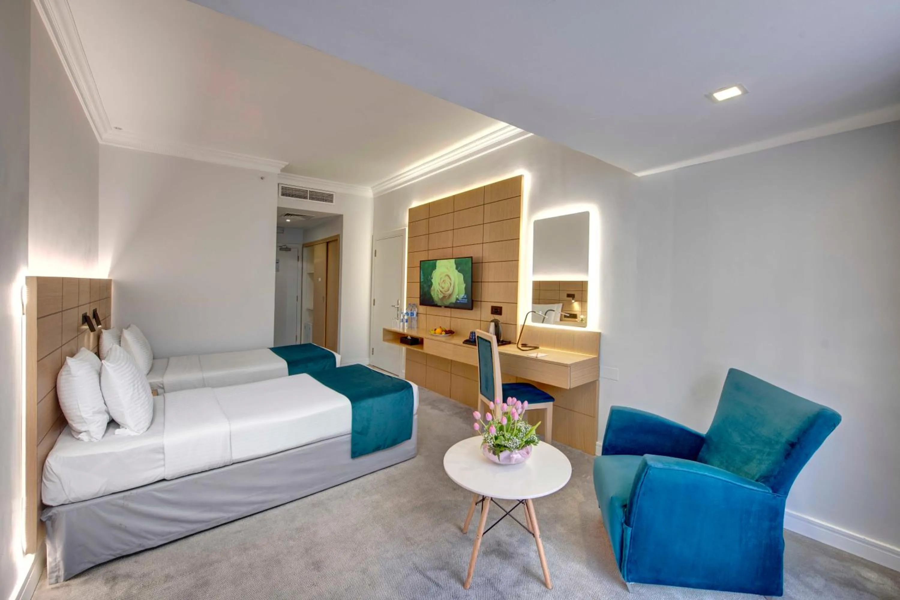 Communal lounge/ TV room, Bed in Lotus Grand Hotel