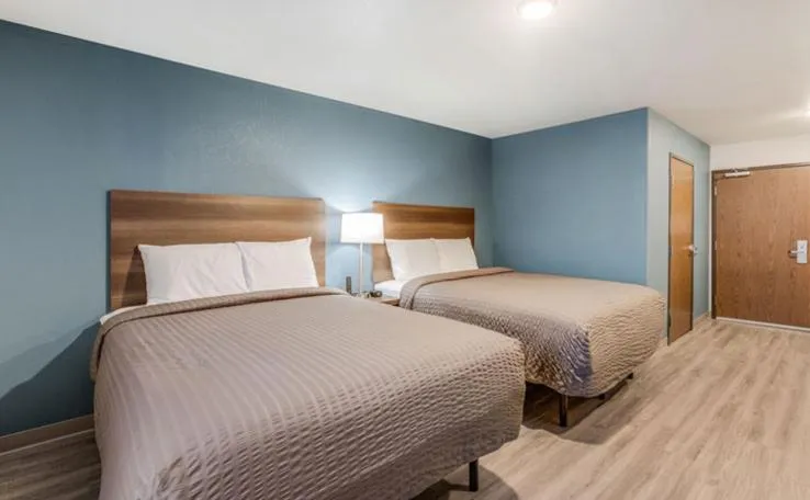 Bed in WoodSpring Suites Detroit Farmington Hills