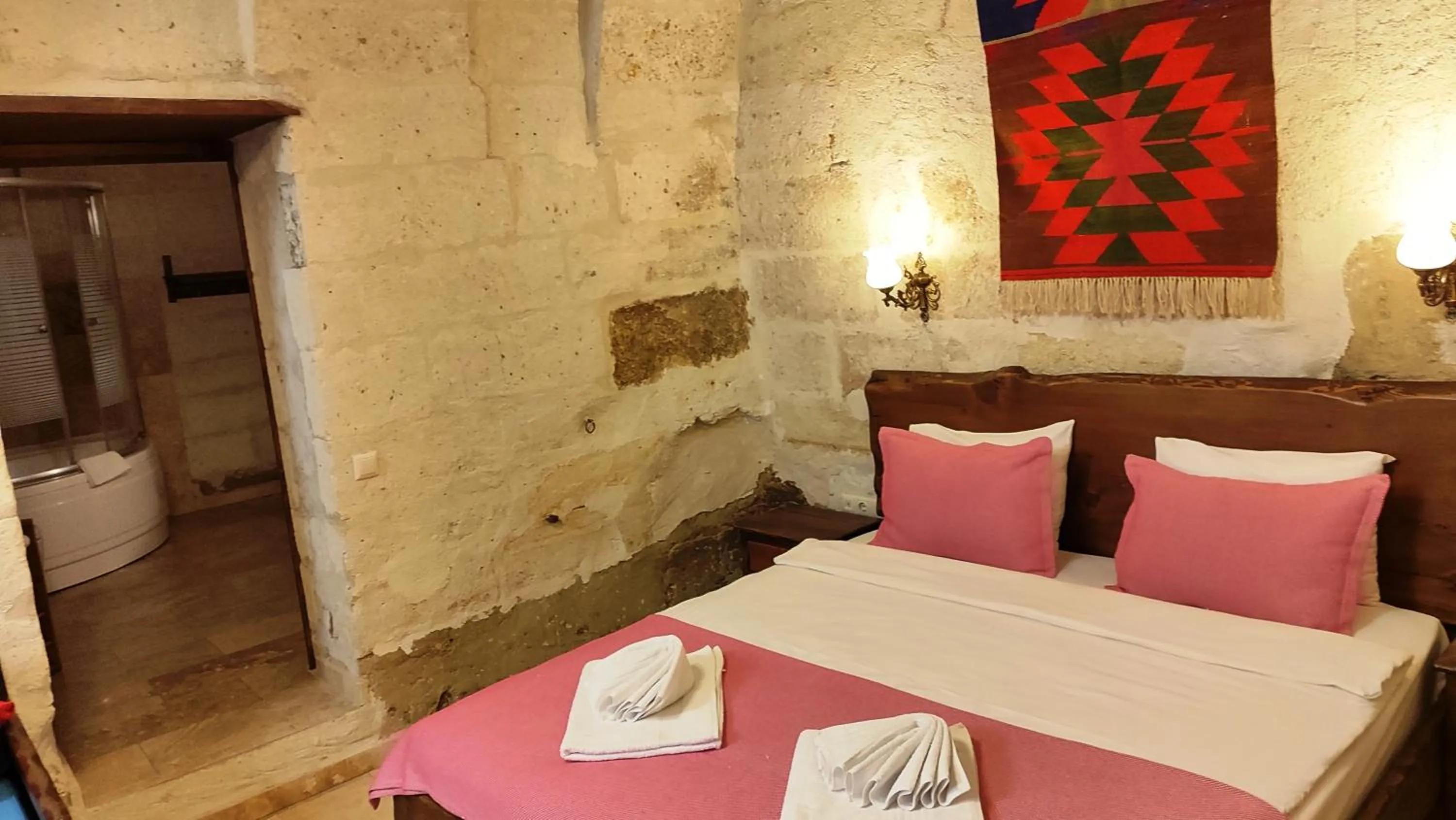 Bed in ARMEsos Cave Hotel