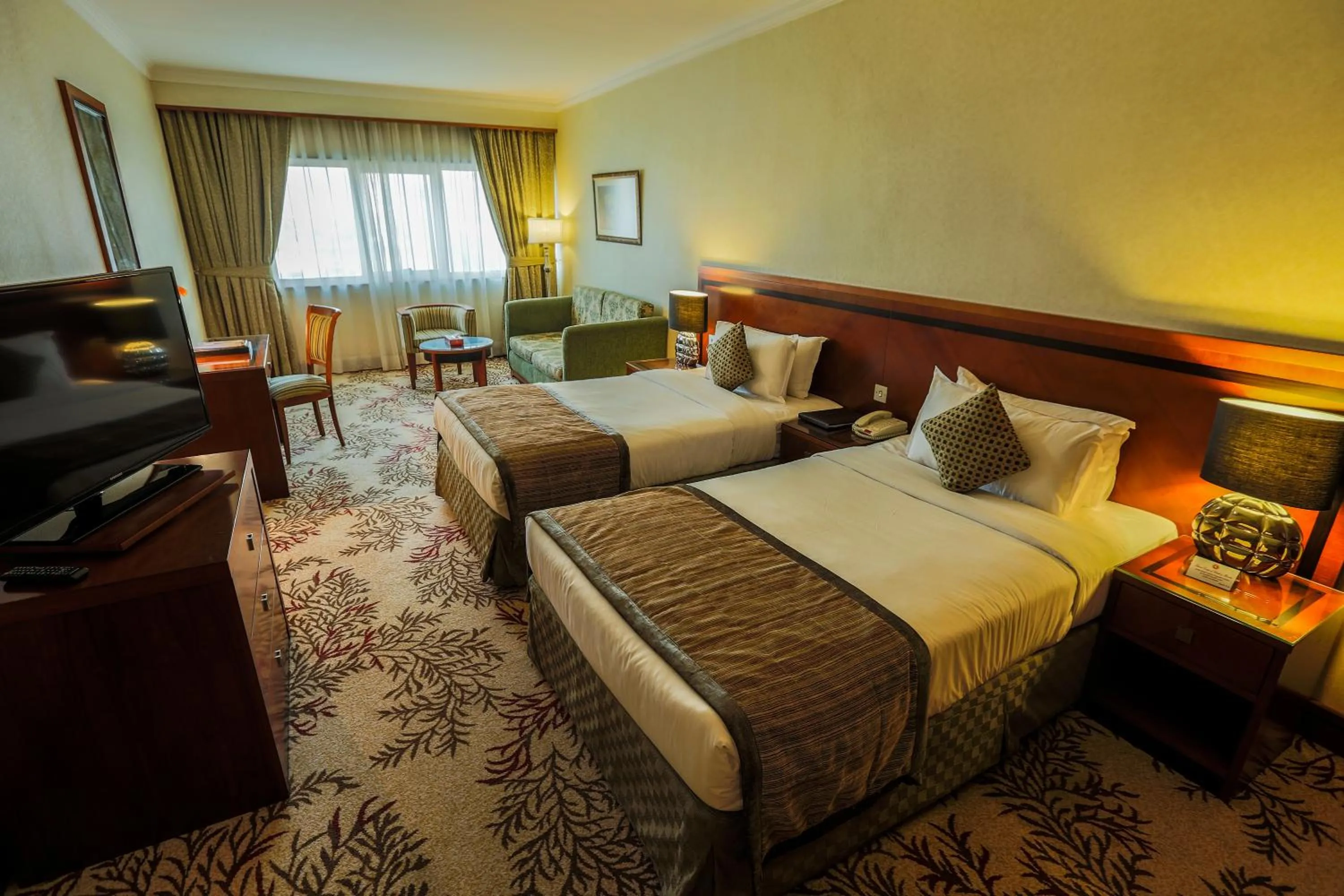 Bed in Ramee Royal Hotel