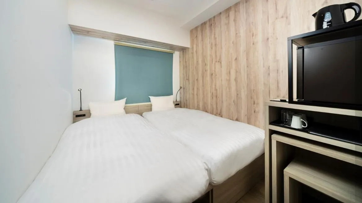 Bed in KOKO HOTEL Kagoshima Tenmonkan