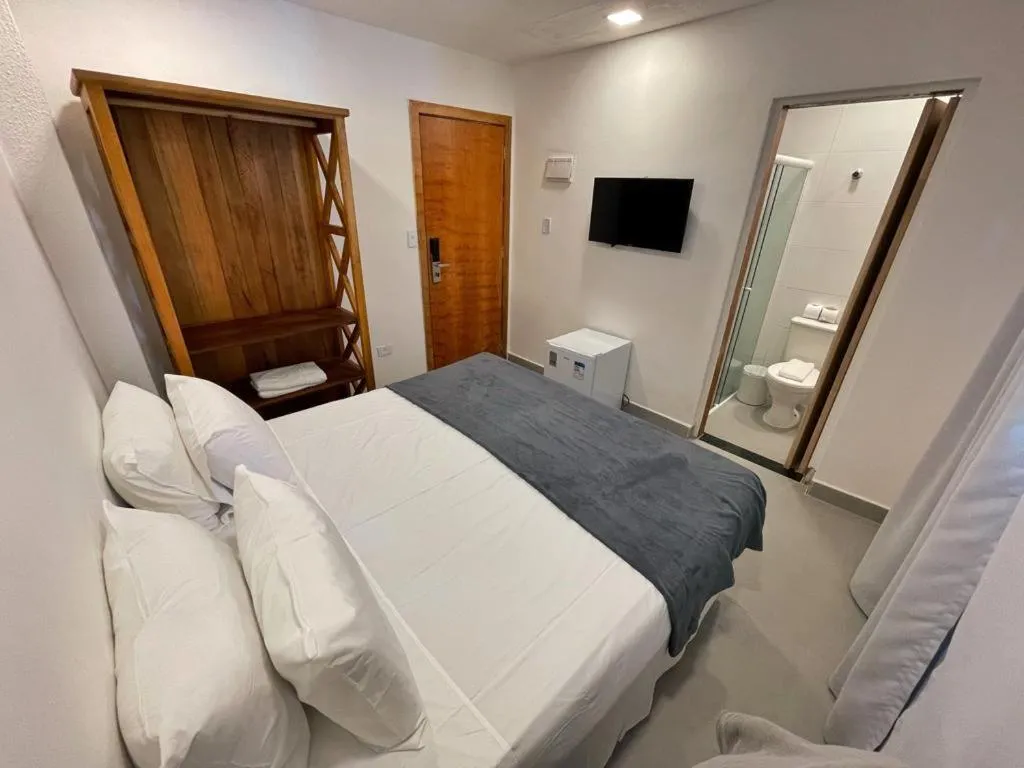 Bed in Hotel Cajueiro Guarujá