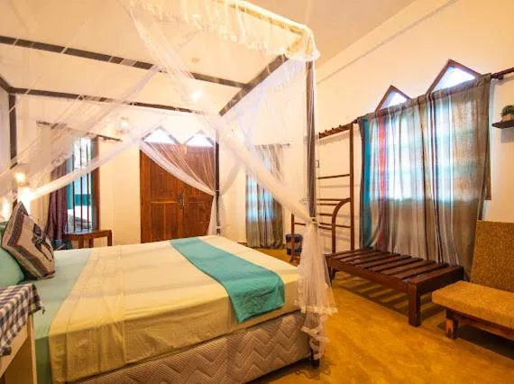 Bed in Frangipani Beach Villa