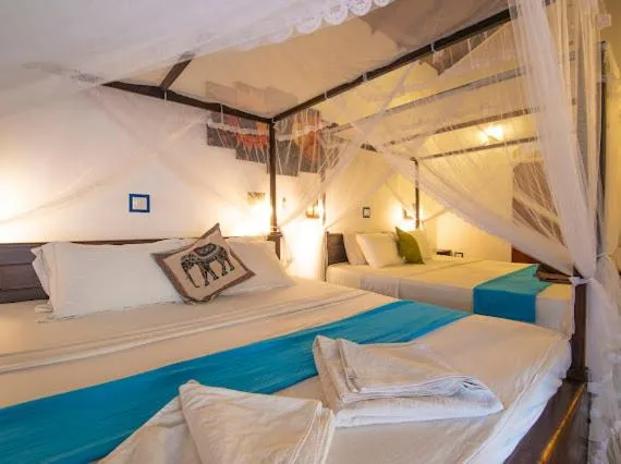 Bed in Frangipani Beach Villa