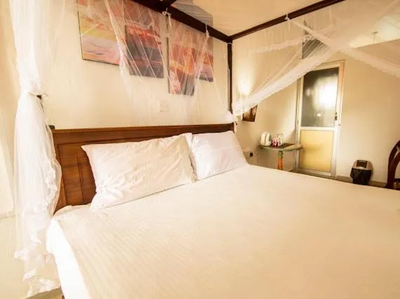 Bed in Frangipani Beach Villa