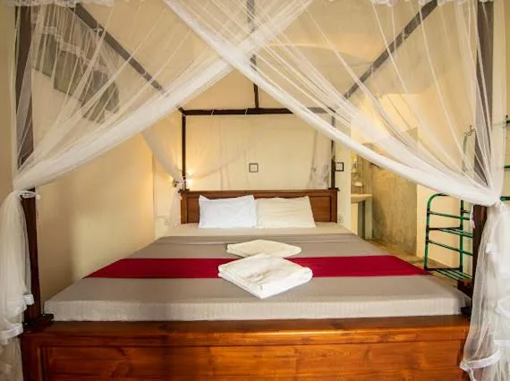 Bed in Frangipani Beach Villa