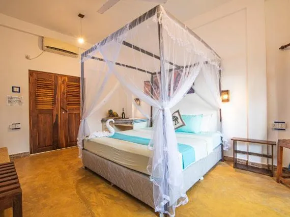 Bed in Frangipani Beach Villa
