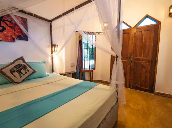 Bed in Frangipani Beach Villa