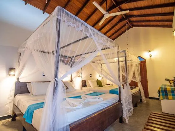 Bed in Frangipani Beach Villa