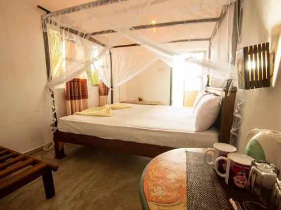 Bed in Frangipani Beach Villa