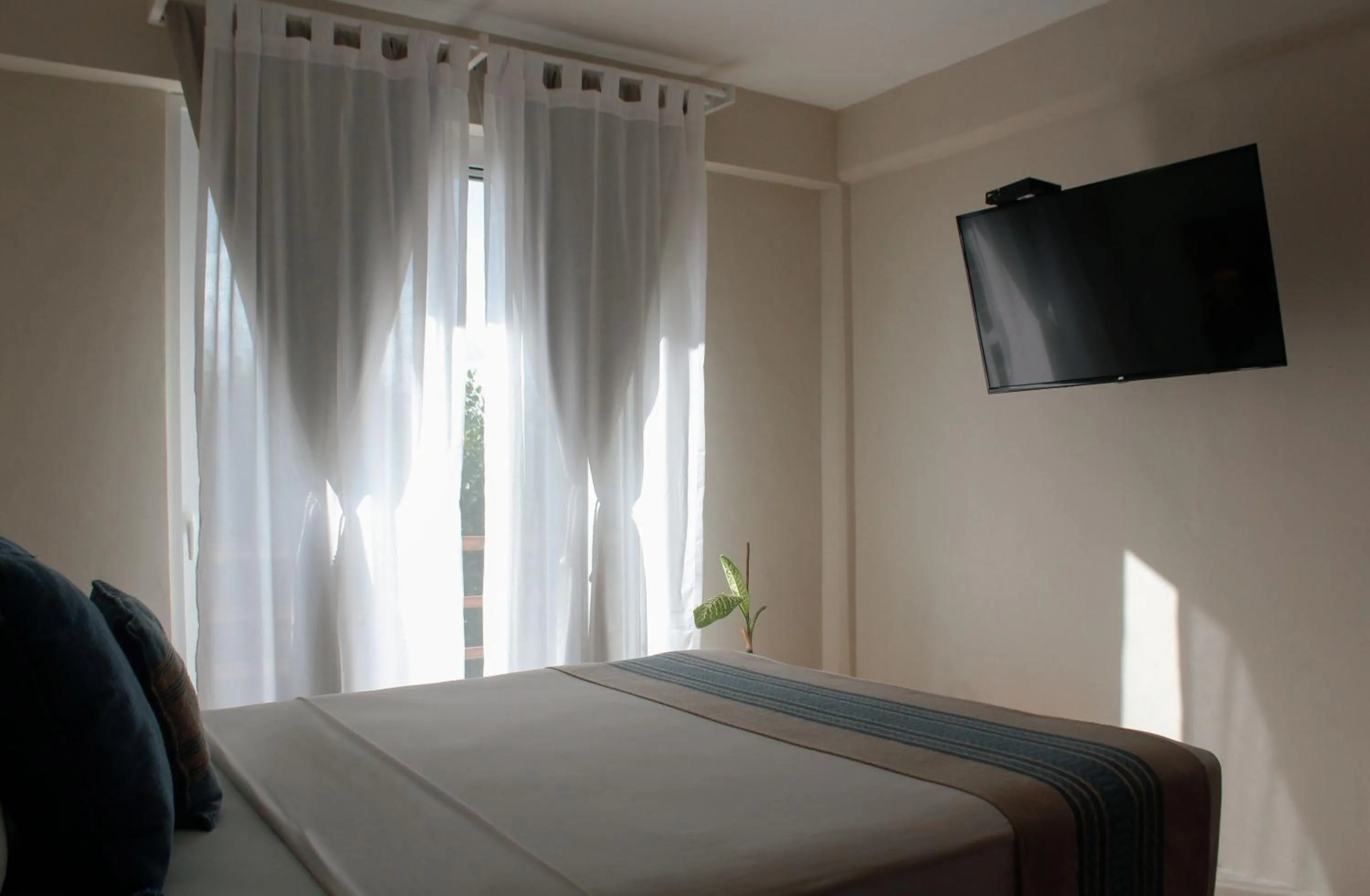 Bed in Noah Beach Hotel & Suites