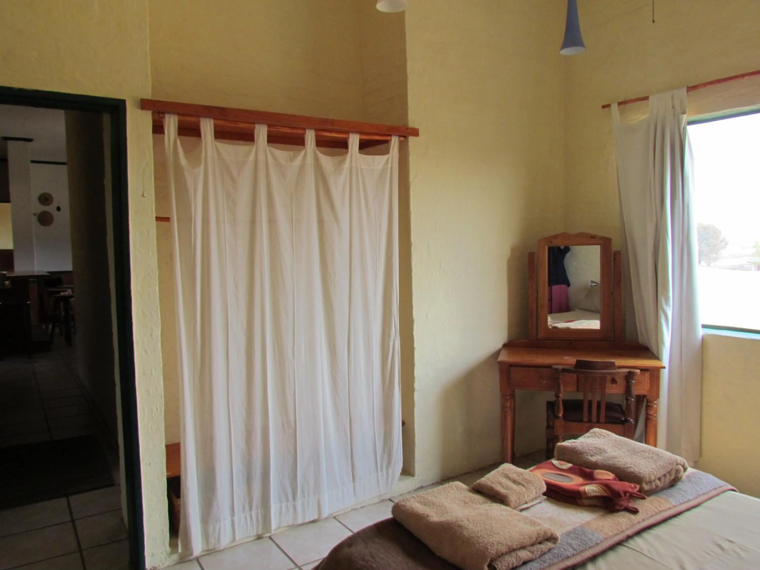 Seating area, Bed in Pumula Guest Farm