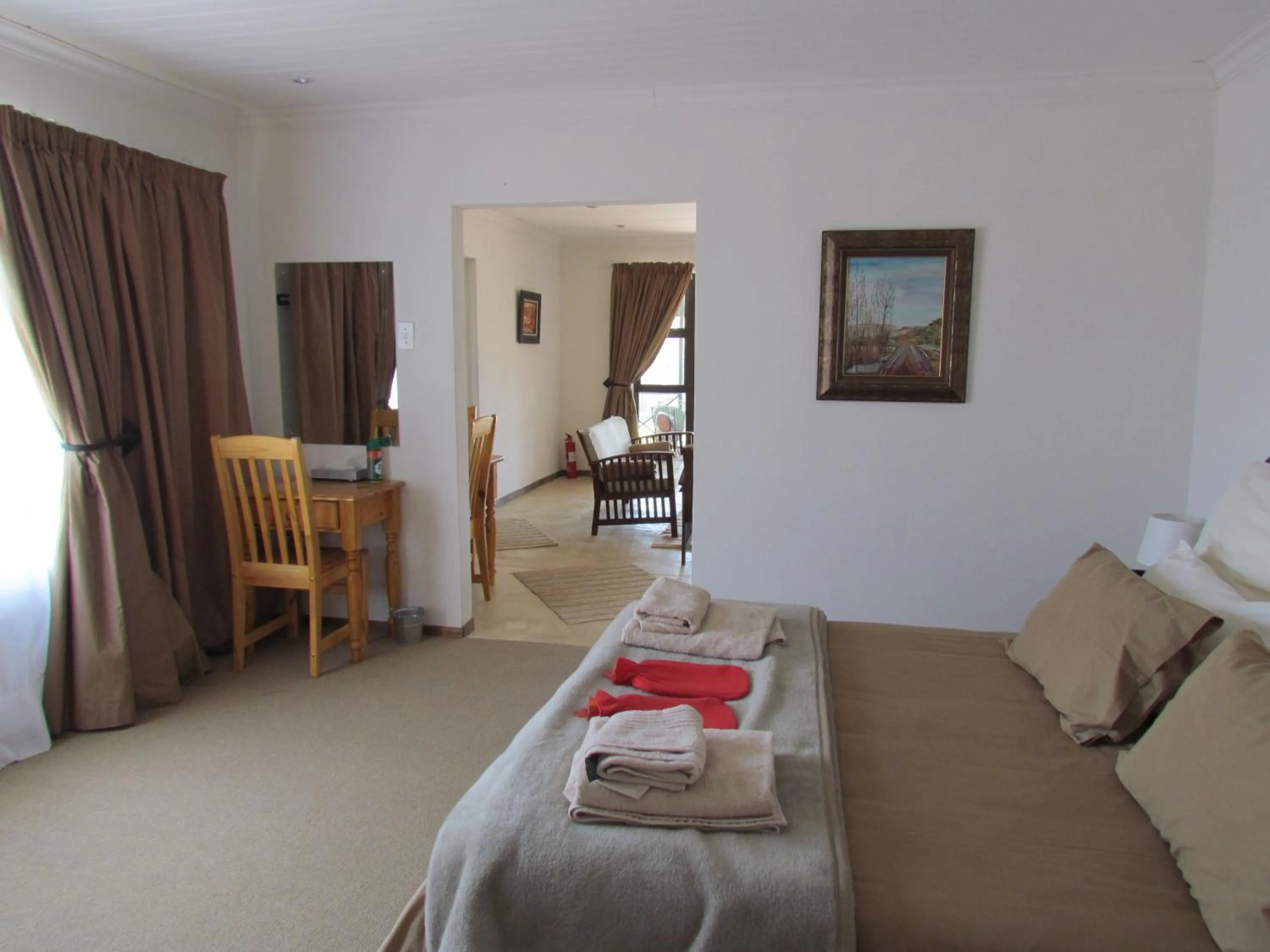 Seating area, Bed in Pumula Guest Farm