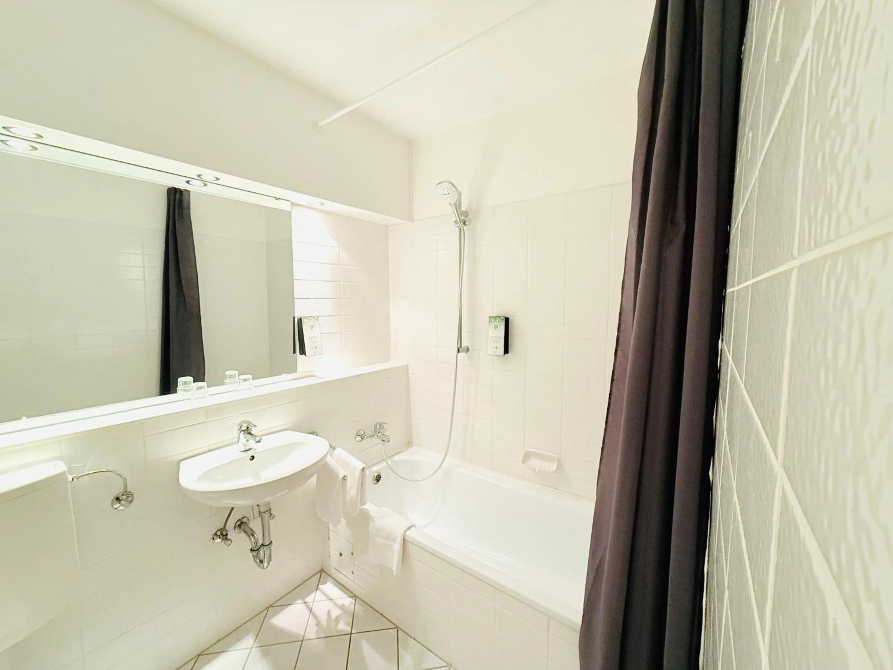 Bathroom in Hotel Plöner See by Tulip Inn