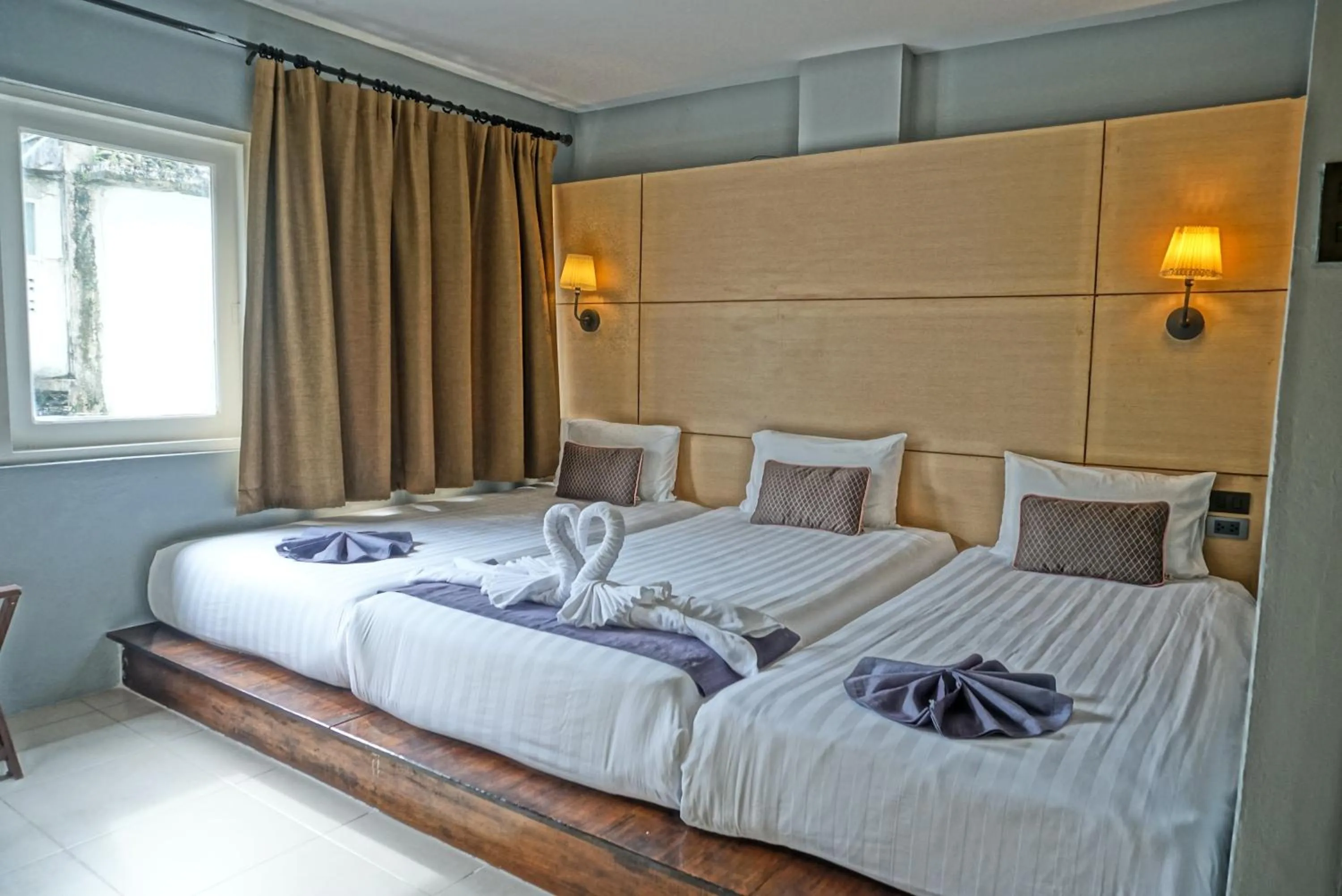 Bed in Montree Phuket Hotel
