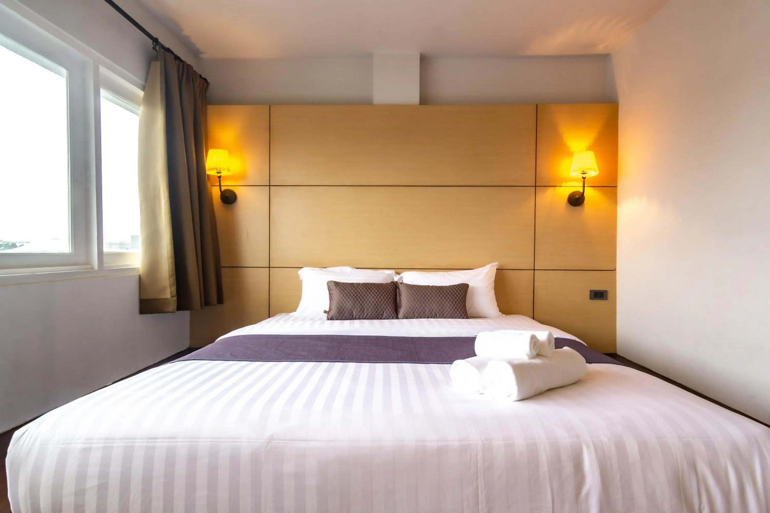 Bed in Montree Phuket Hotel