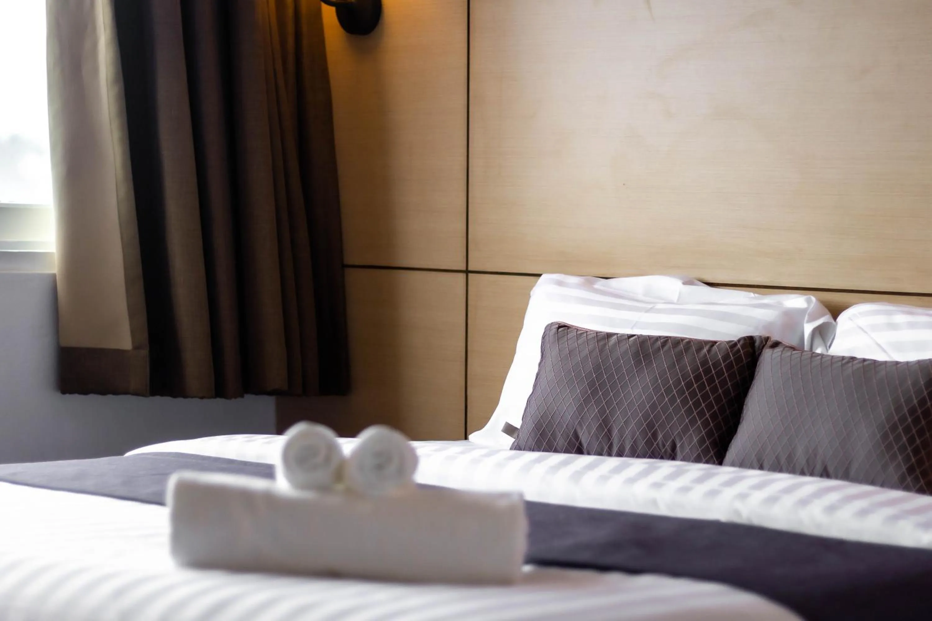 Bed in Montree Phuket Hotel