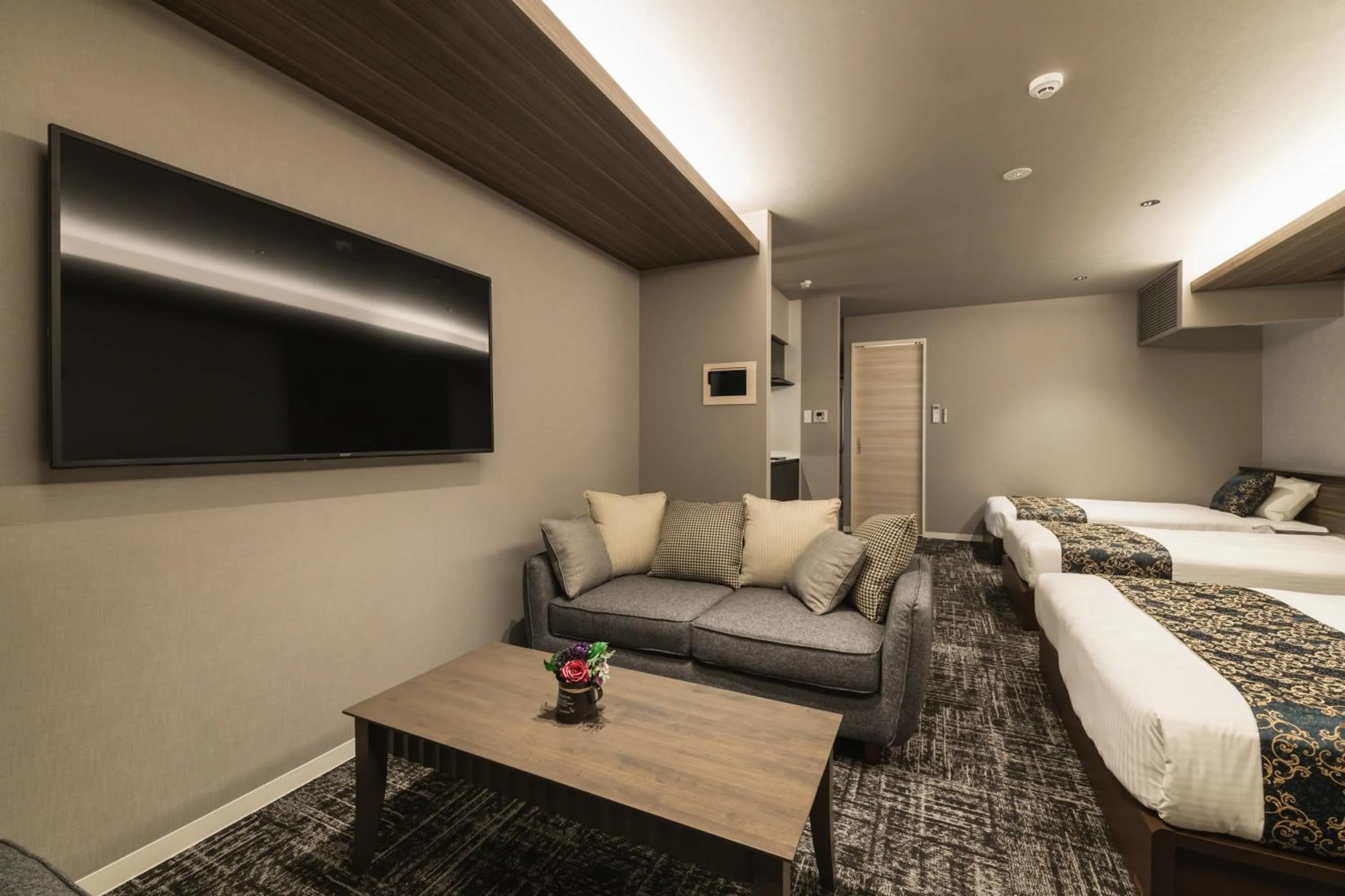 Living room, Bed in GRAND BASE Kagoshima Tenmonkan