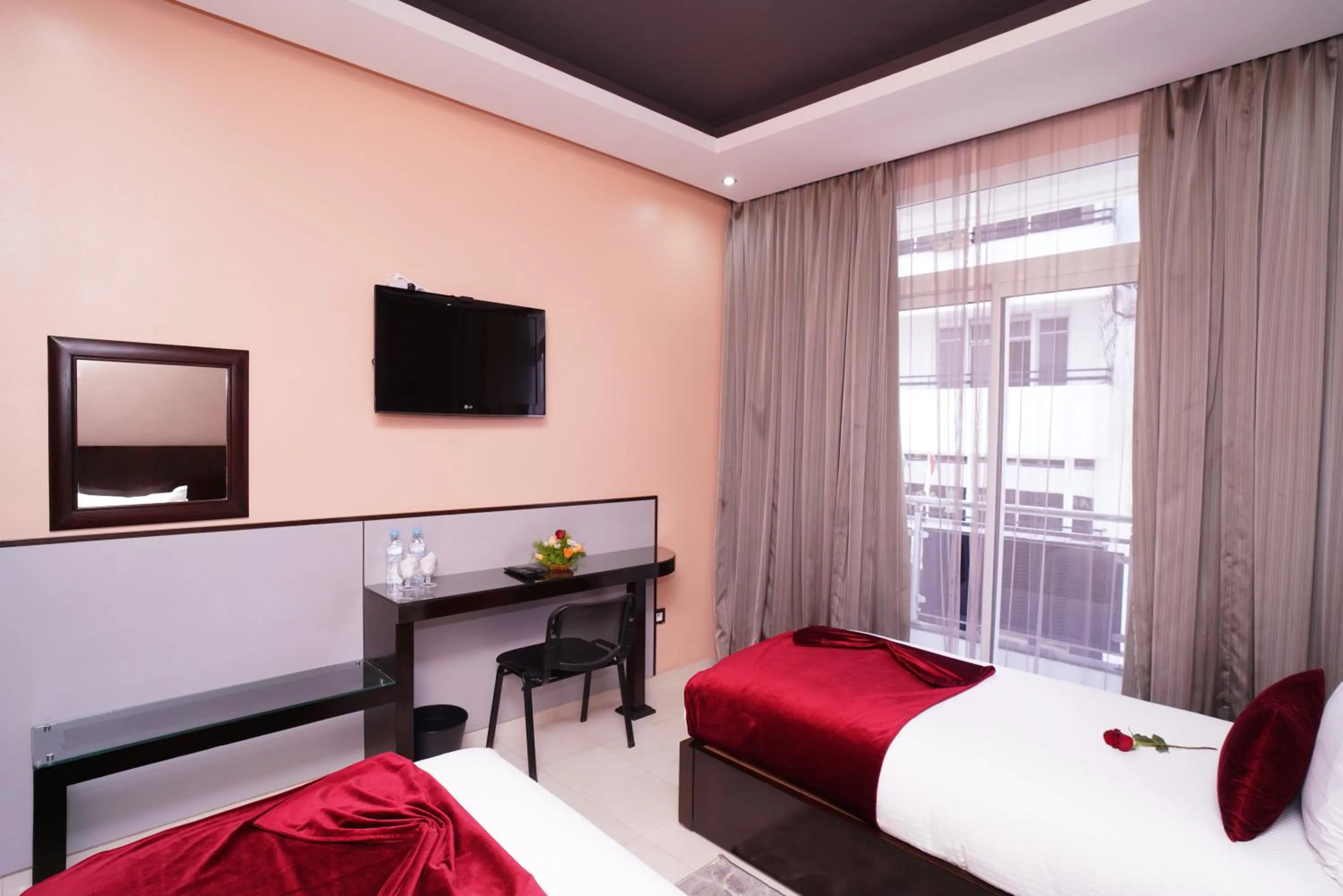 Communal lounge/ TV room, Bed in Hotel La Capitale