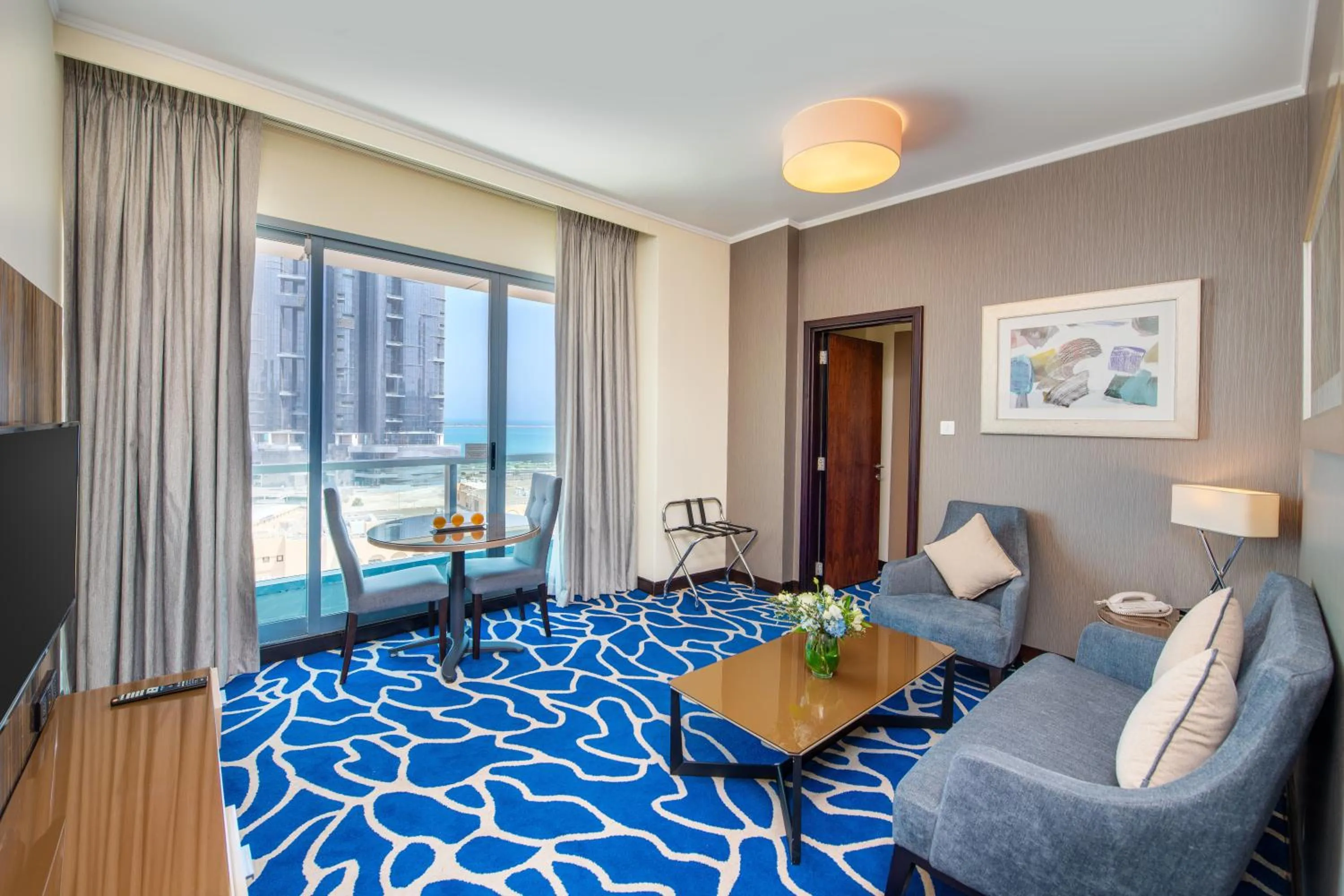 Living room, Bed in Hawthorn Suites by Wyndham Abu Dhabi City Center