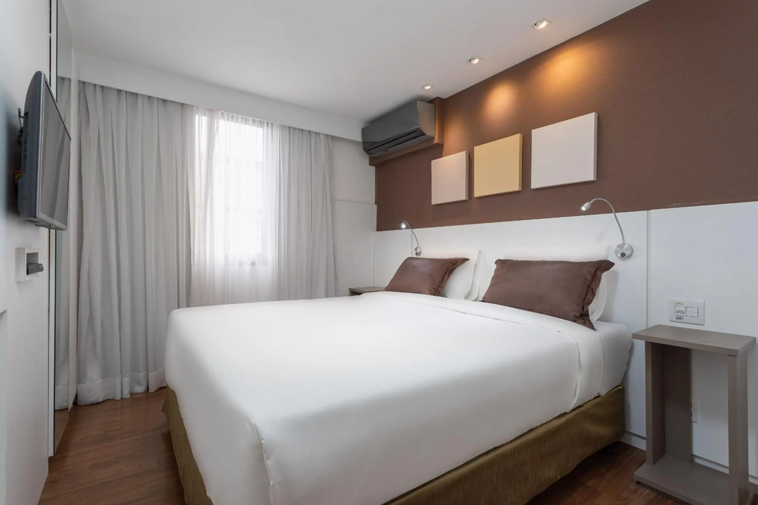 Bed in Paulista Suites by Charlie