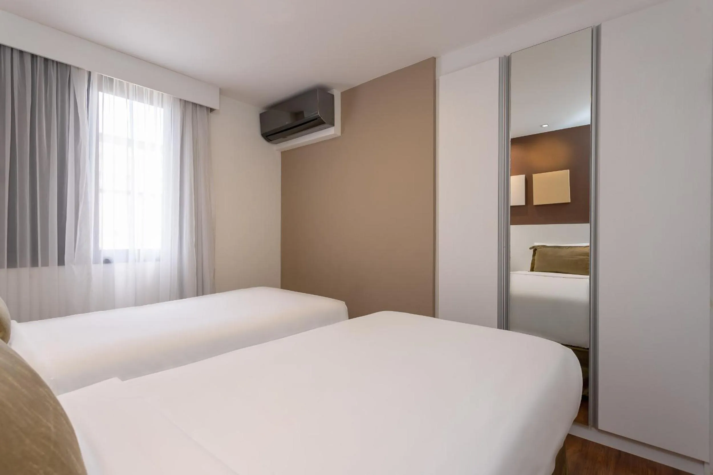 Bed in Paulista Suites by Charlie