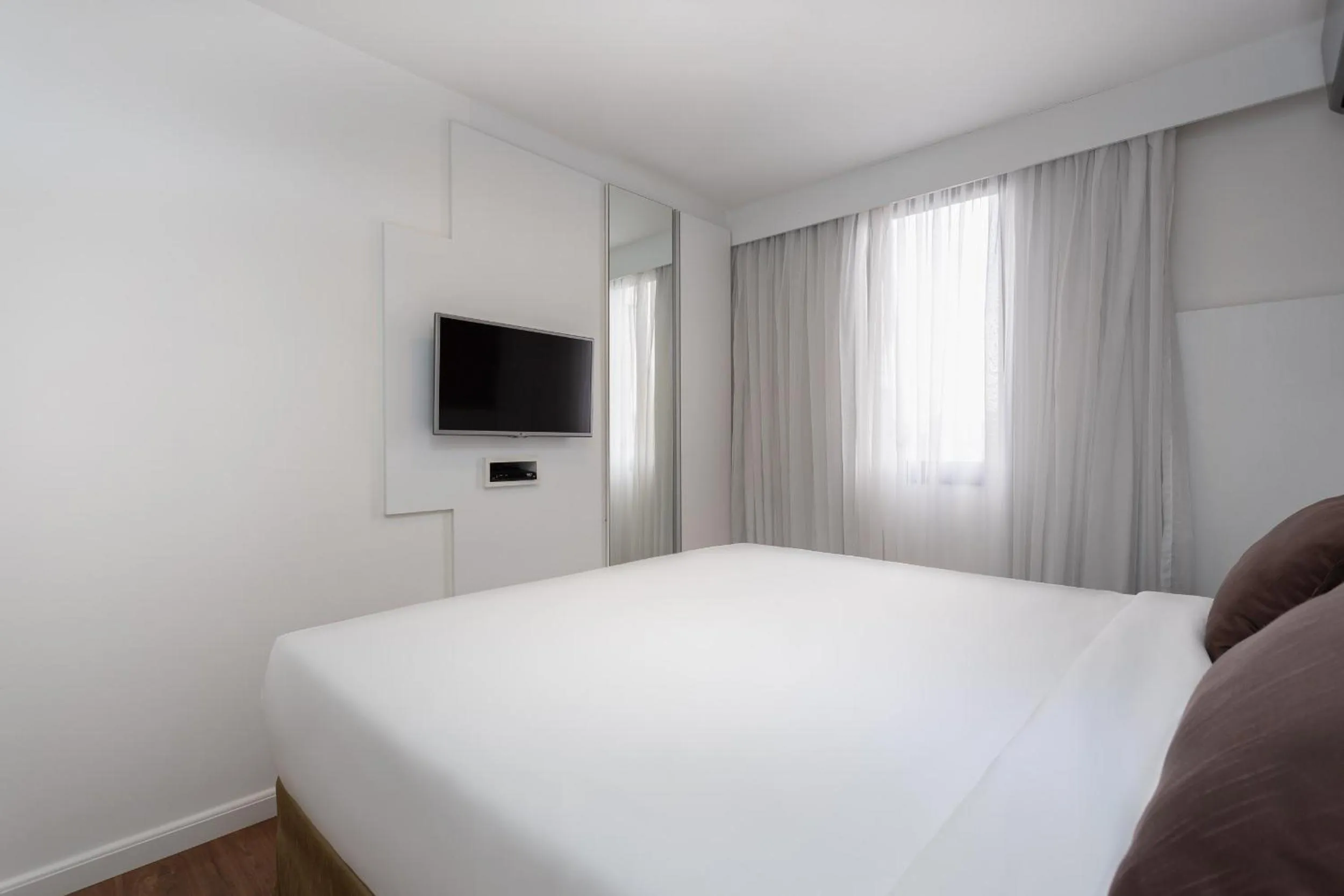 Bed in Paulista Suites by Charlie