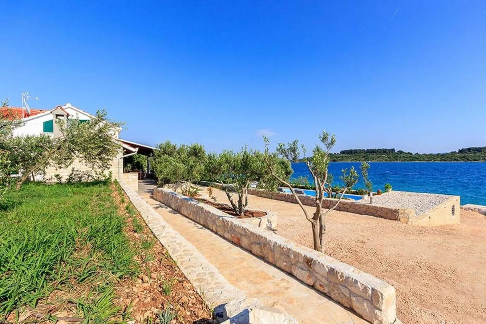 Property building in Luxury Beachfront Villa Dalmatino Trogir with private pool right at the beach in Okrug Gornji - Ciovo