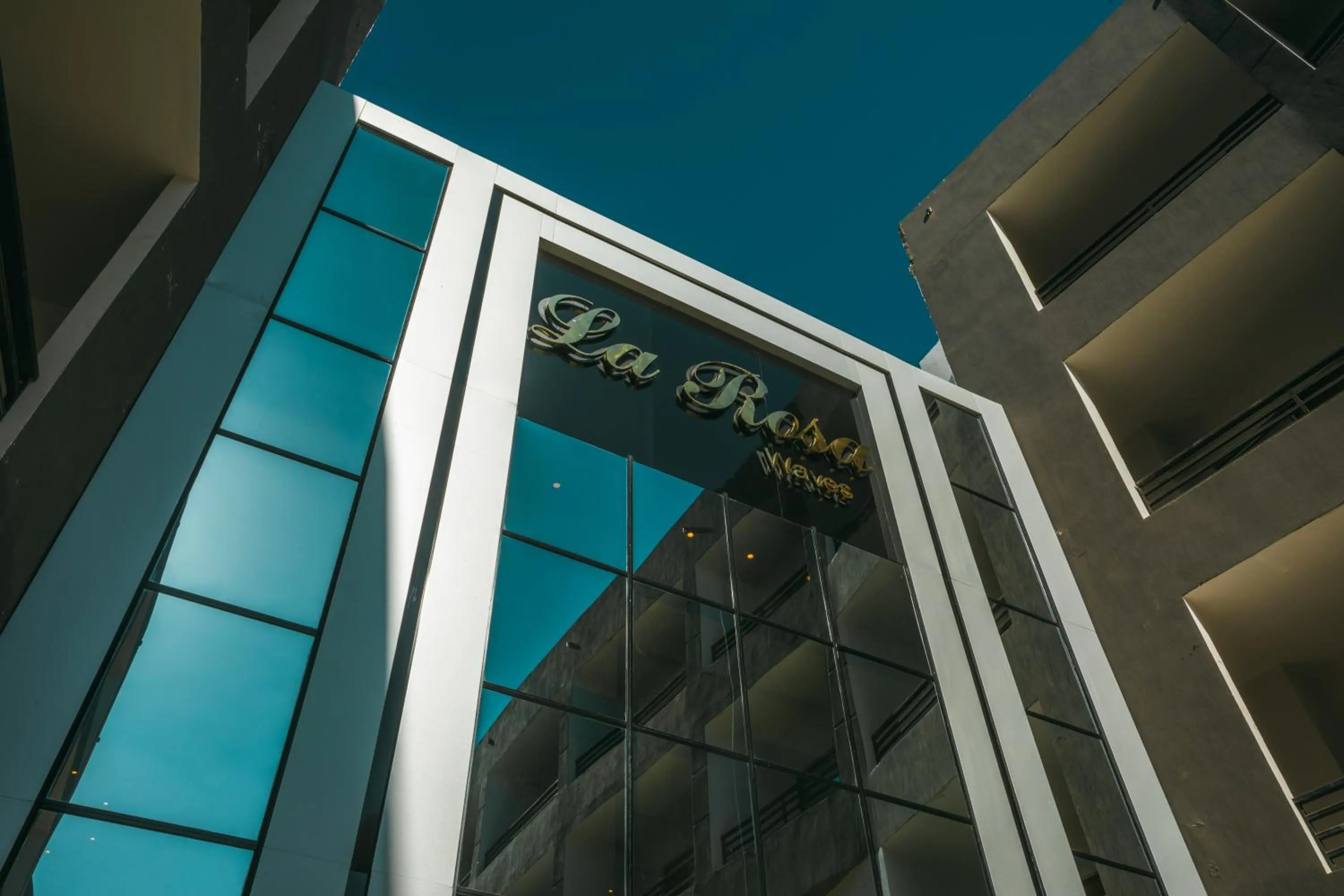 Property logo or sign in La Rosa Waves Beach - Couple & Families Only