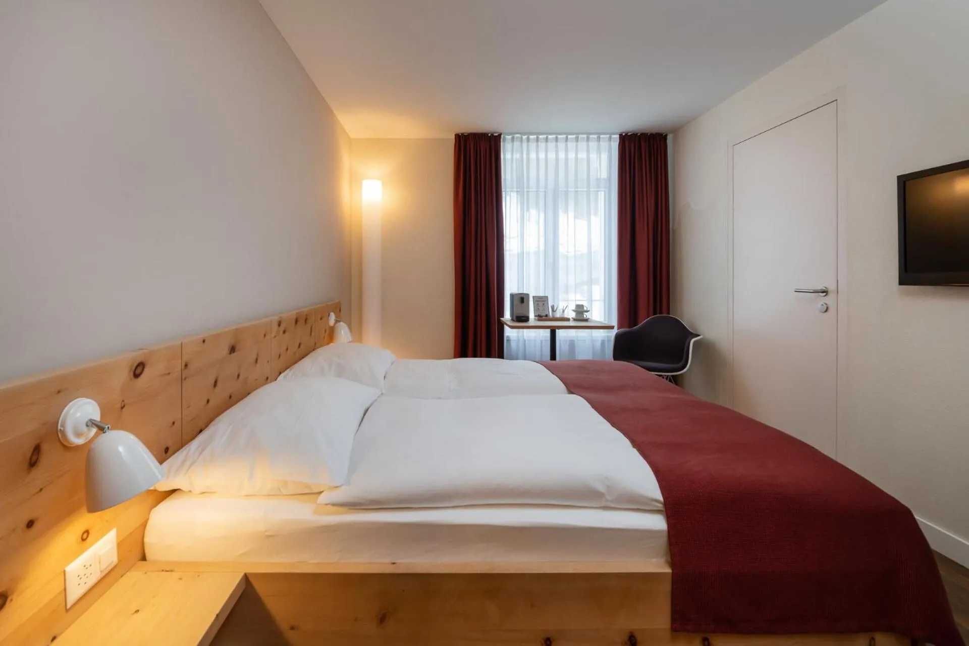 Bed in Hotel Schweizerhof Sils Maria, a Faern Collection Hotel