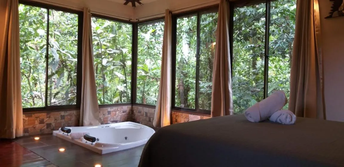 Bed in Tropical Suites & Villas