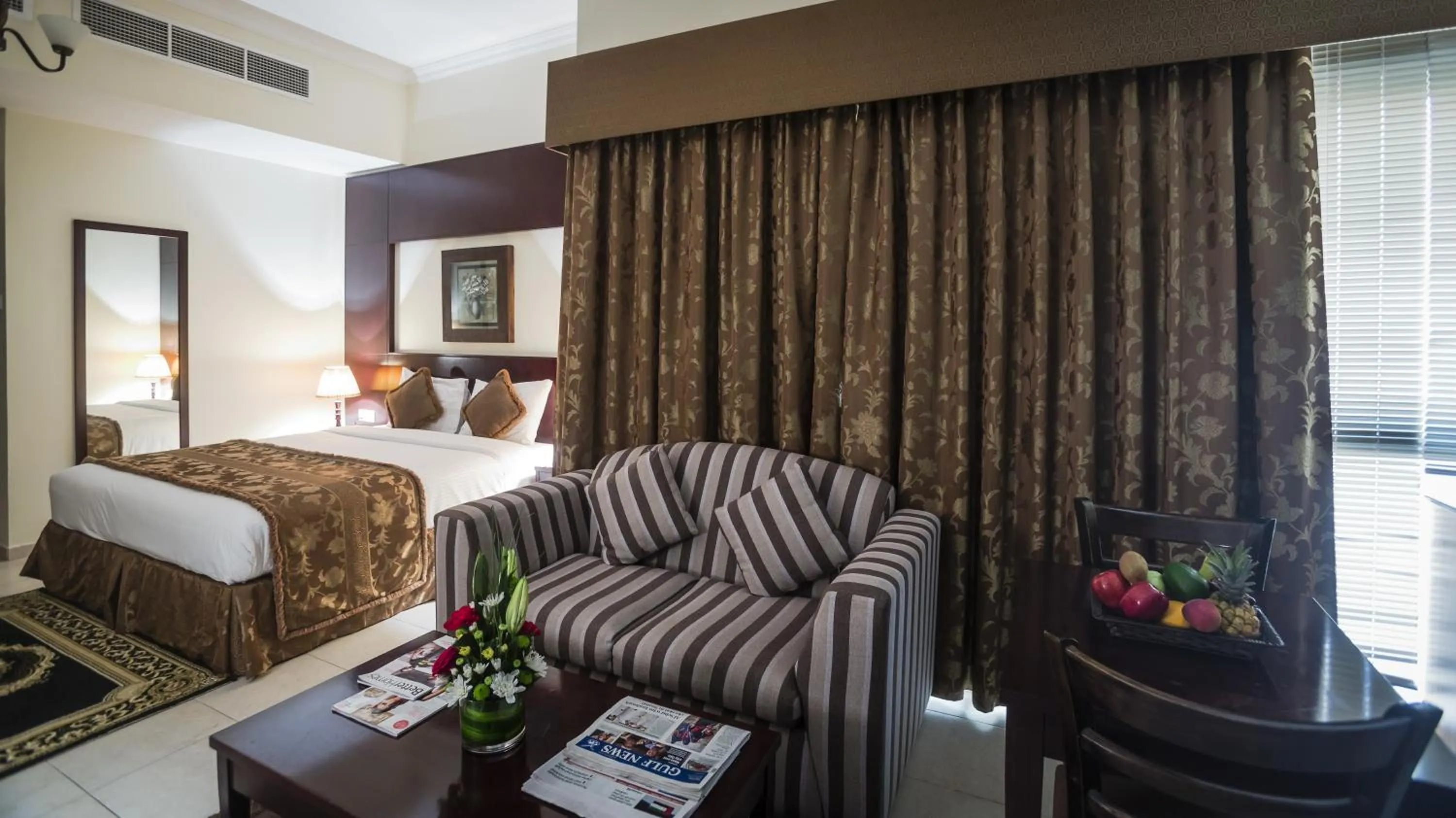 Living room, Bed in Arabian Dreams Hotel Apartments