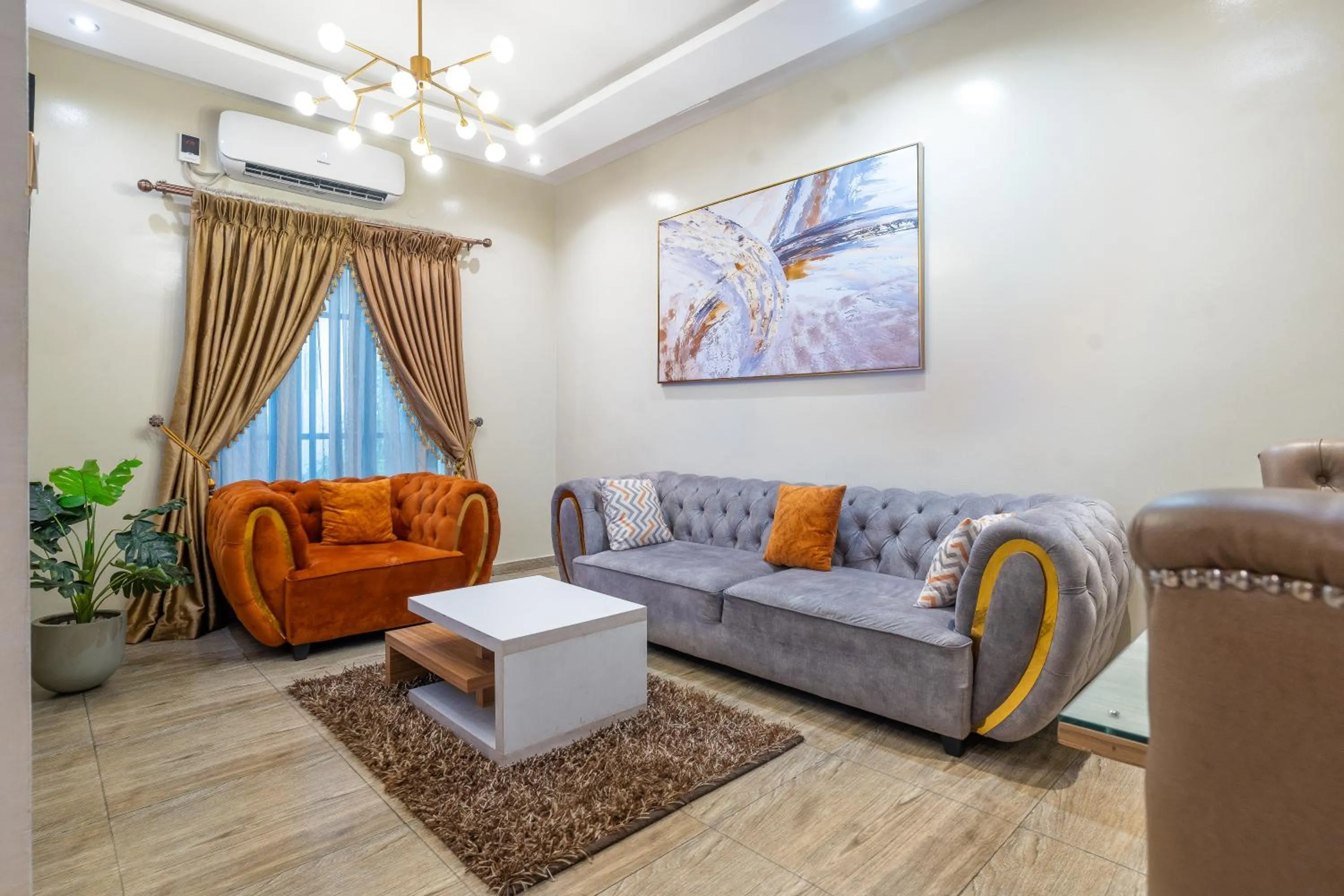 Living room in God's Touch Apartments Signature