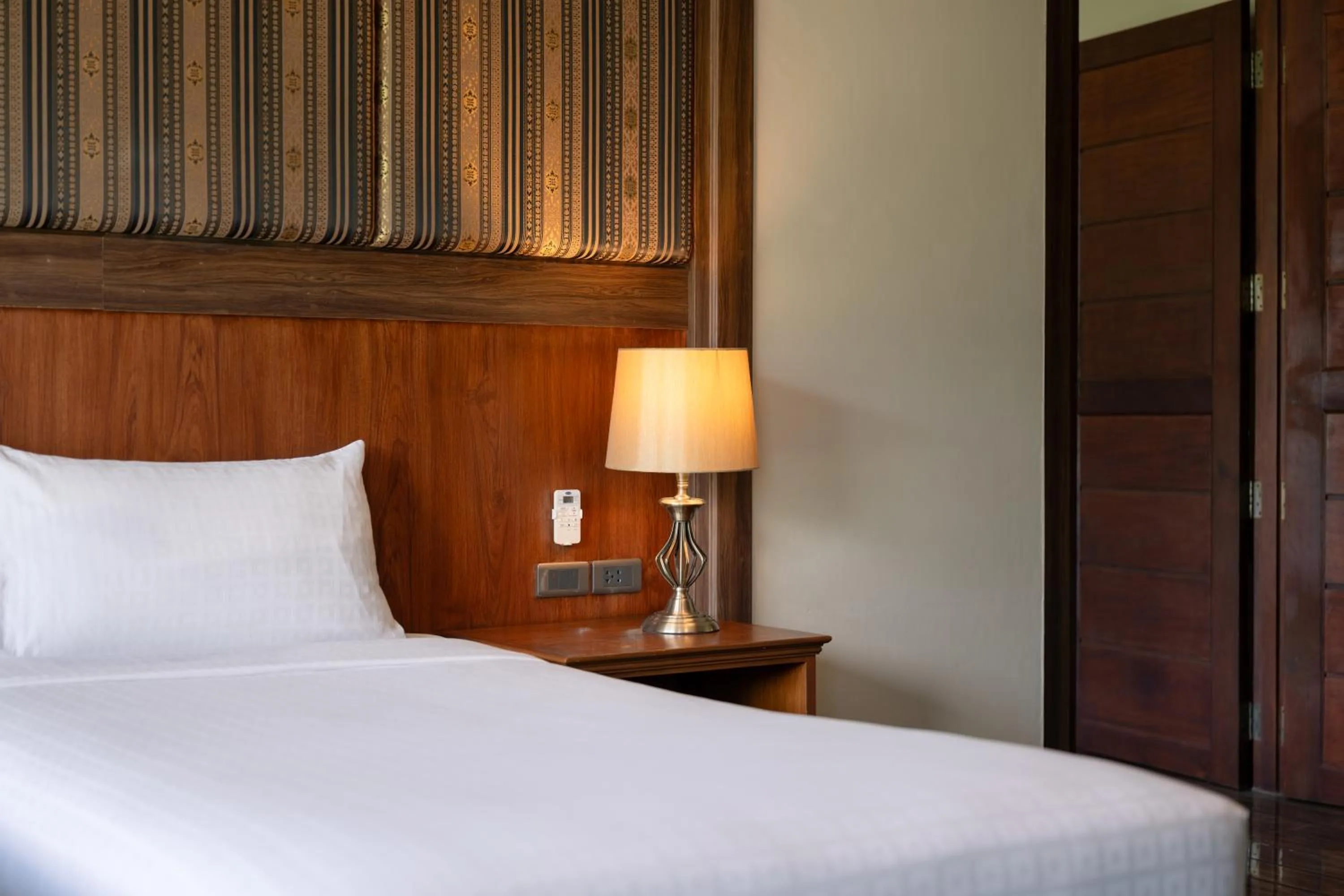 Bed in Le Erawan Phang Nga Hotel