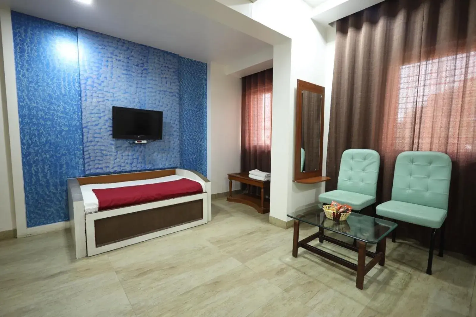 Communal lounge/ TV room, Bed in Saish Hotel Shirdi Communal lounge/ TV room, Bed in Saish Hotel Shirdi