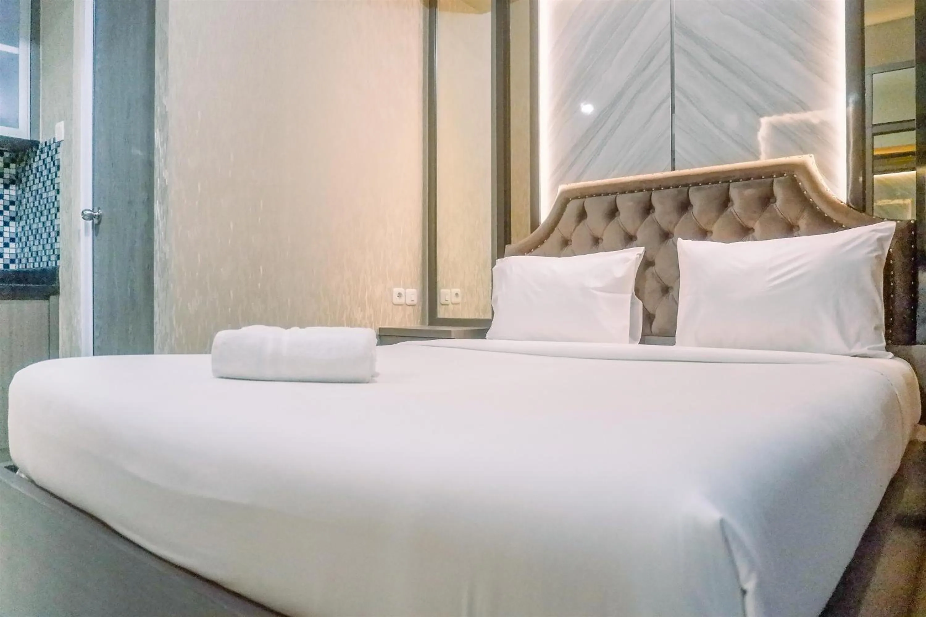 Bed in Classic Studio Room Apartment at Taman Melati Surabaya By Travelio