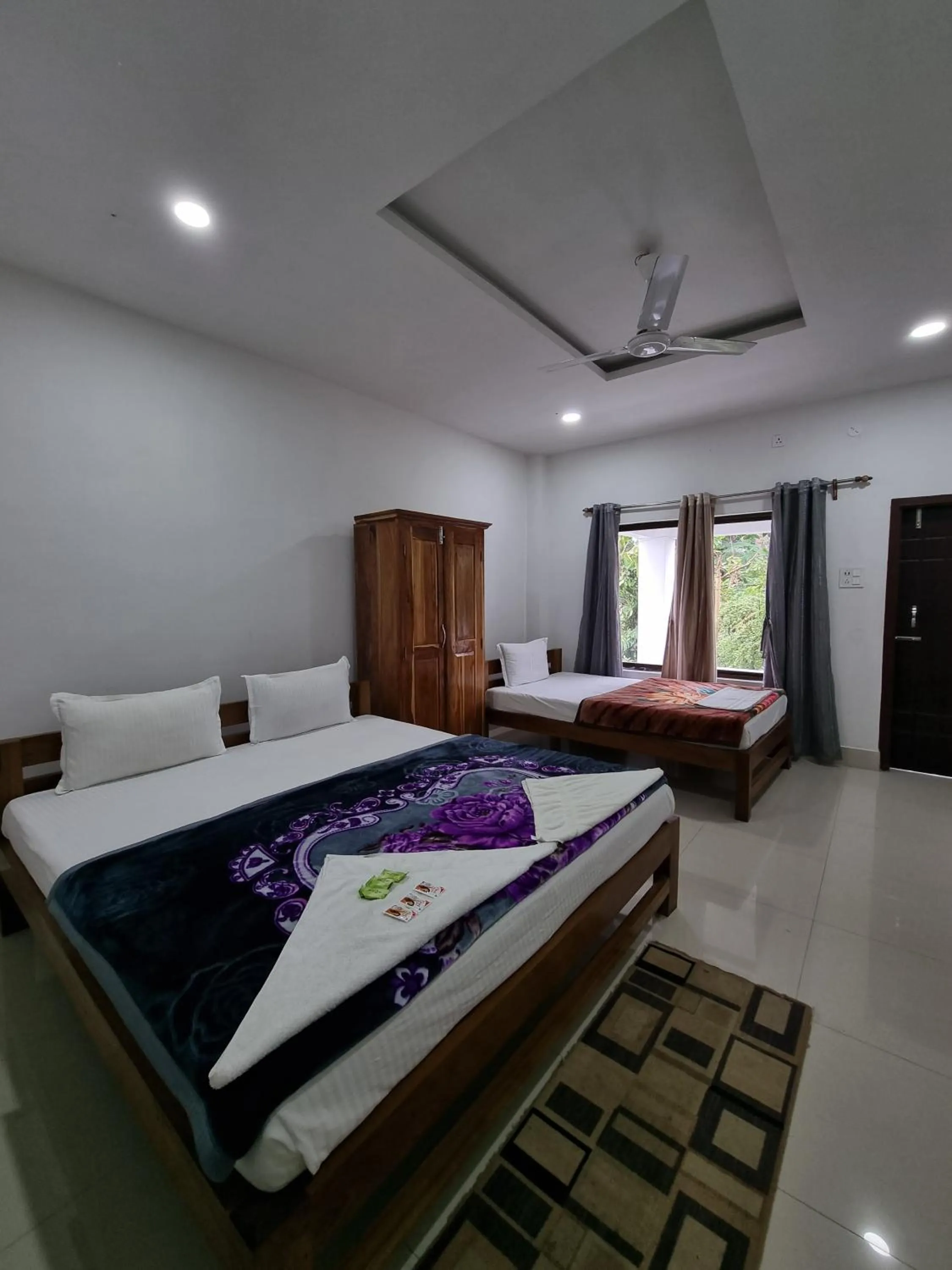 Photo of the whole room, Bed in Shivaji Inn Kaziranga