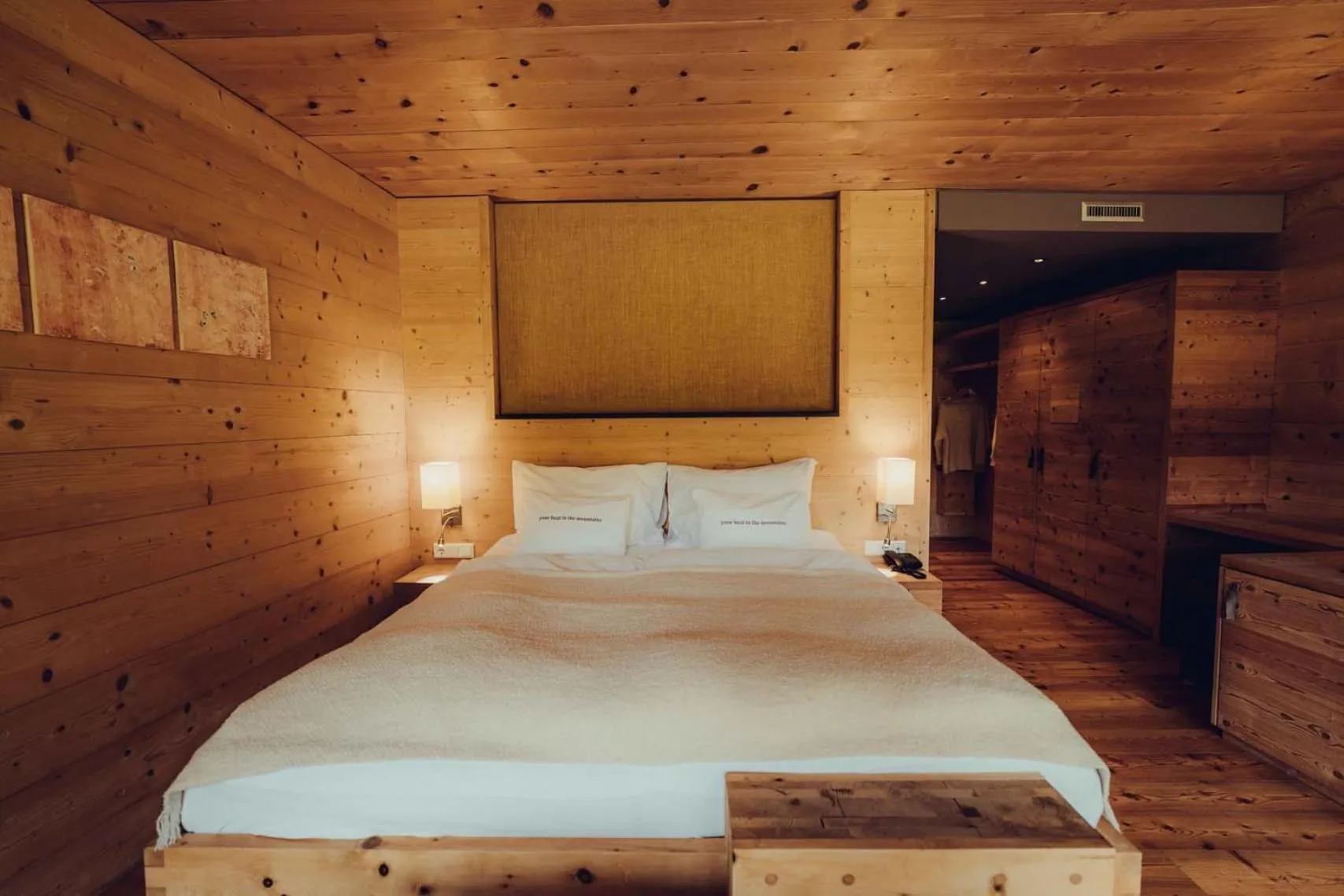 Bed in Holzhotel Forsthofalm