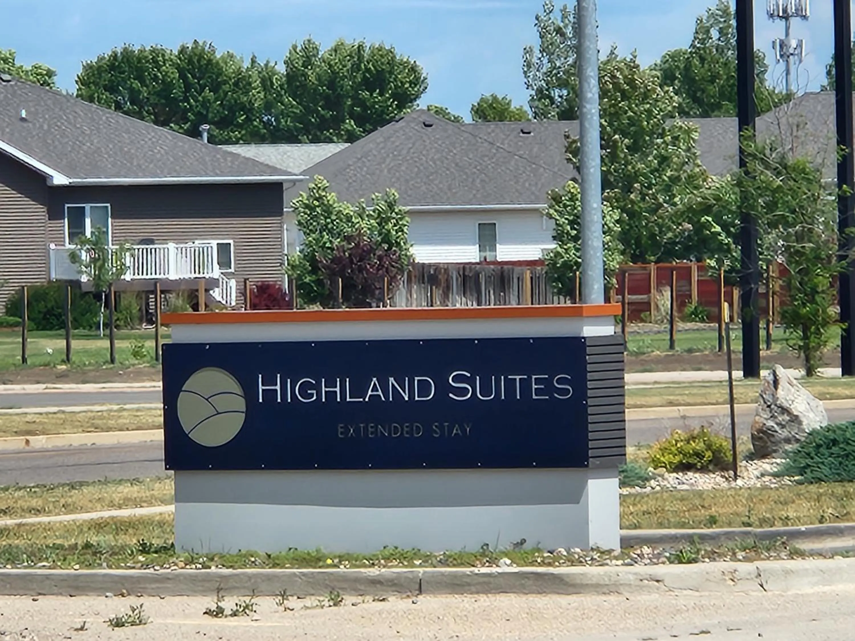 Property logo or sign in Highland Suites Minot