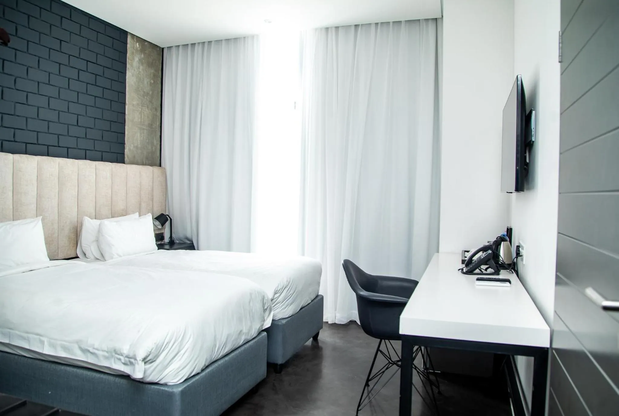 Seating area, Bed in The Urban Hotel Lusaka