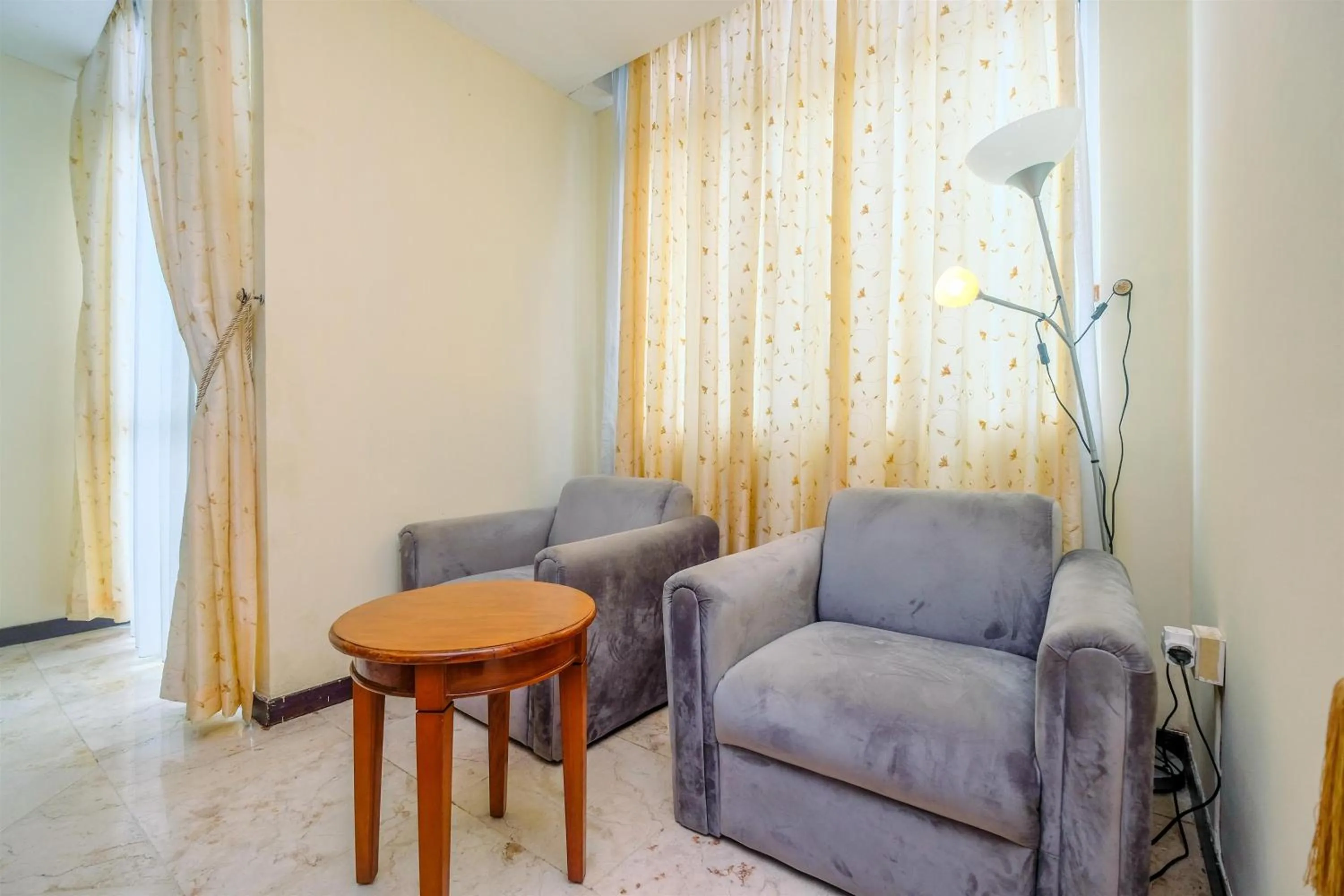 Living room in Exclusive with City View 3BR Apartment Bellagio Residence By Travelio