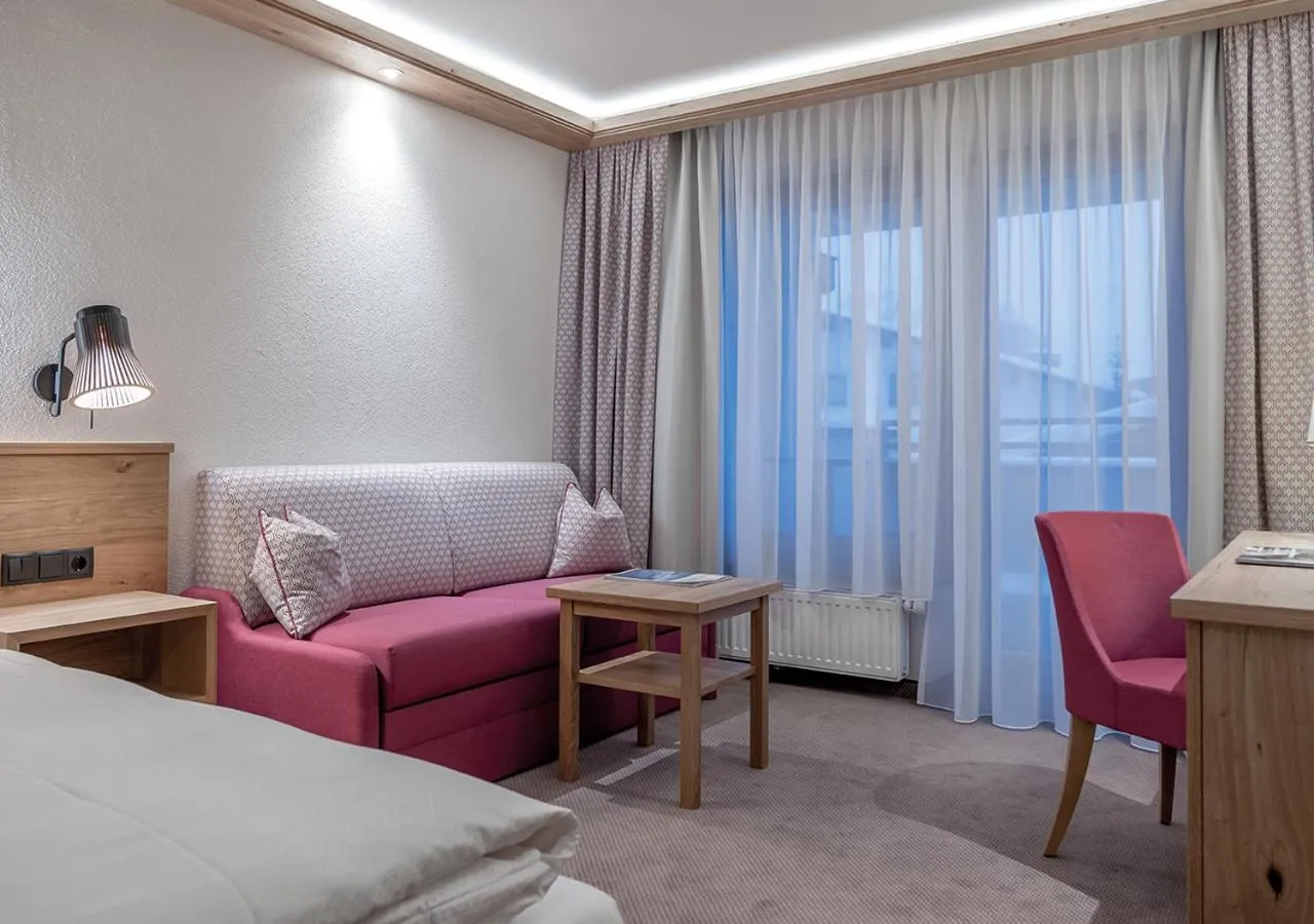 Seating area, Bed in Hotel Alpenland