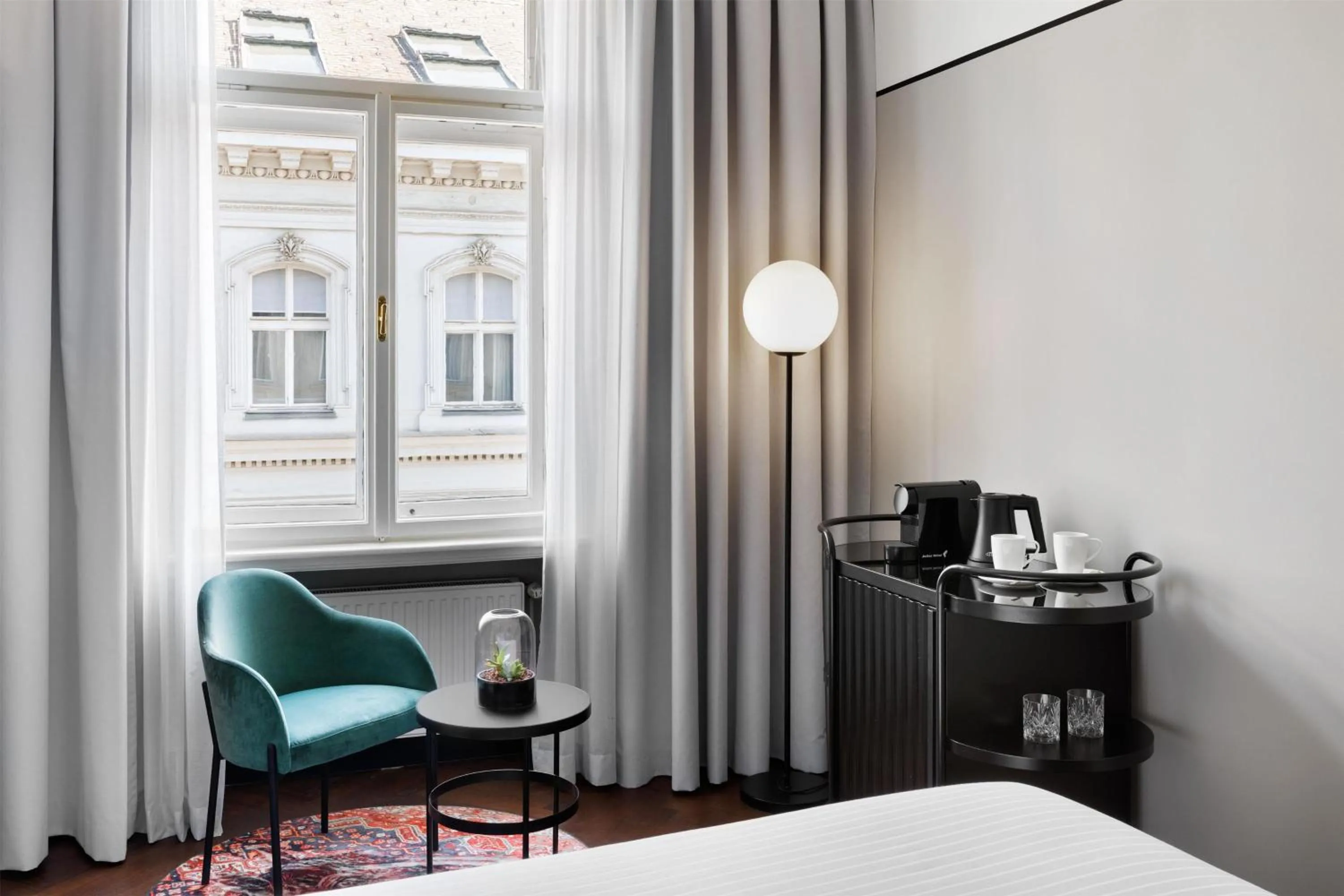 Living room, Bed in Hotel Astoria Vienna, Curio Collection by Hilton