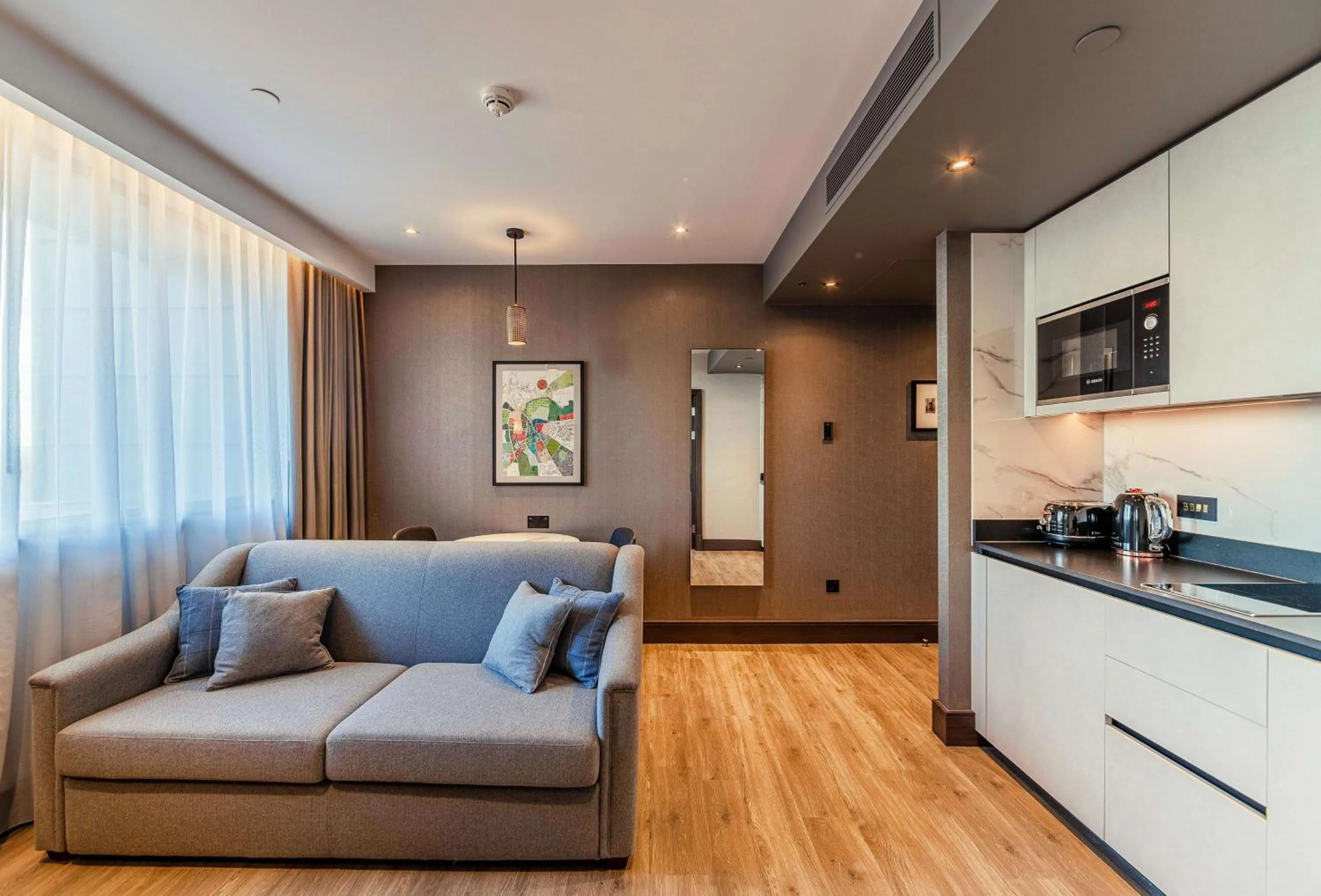 Living room in The Fellows House Cambridge, Curio Collection By Hilton