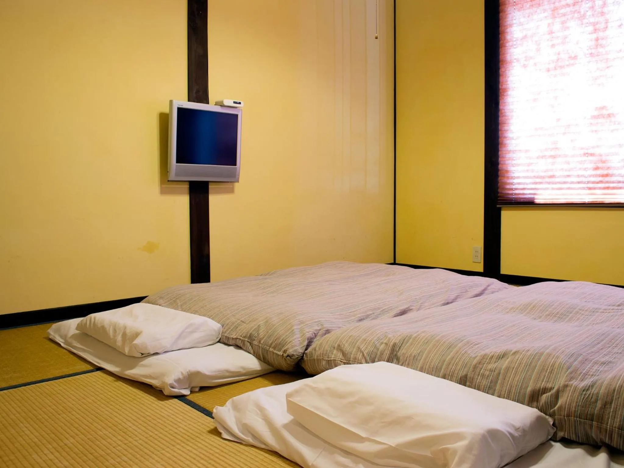 Bed in Tabinoyado Asonoyu