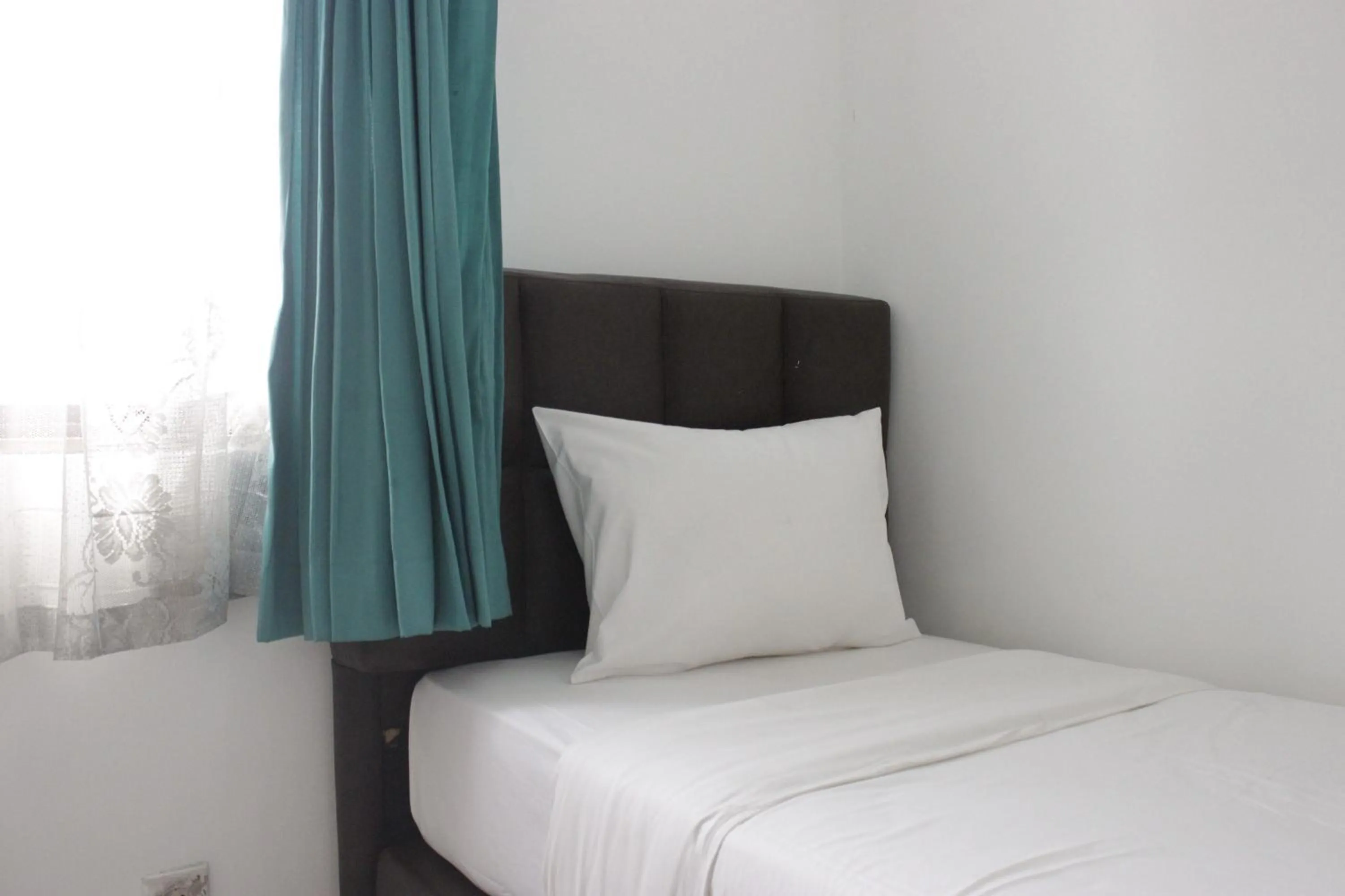 Bed in Homey 2BR Majesty Apartment near Maranatha University By Travelio